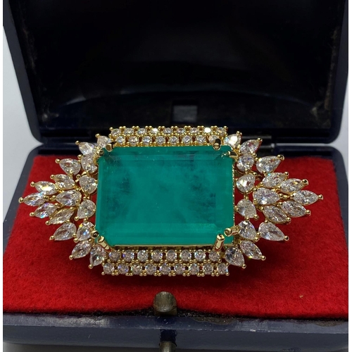 22 - A dress ring with simulated emerald (25x18mm) and sapphires marked 18KGL, designed and signed by 