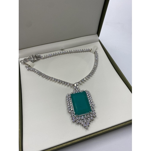 24 - Attractive necklace with simulated emerald (36x25mmm) and sapphires marked 18KGL, designed and signe... 