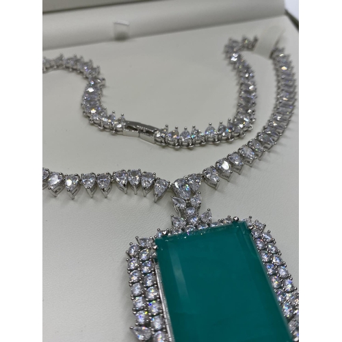 24 - Attractive necklace with simulated emerald (36x25mmm) and sapphires marked 18KGL, designed and signe... 