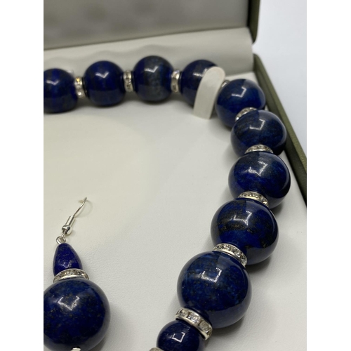 26 - A Lapis Lazuli necklace and earrings set (beads 20mm !). Clasp with cubic zirconia and marked 