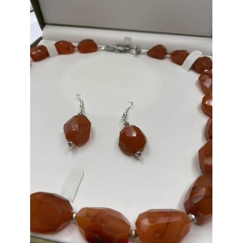 30 - A large beaded carnelian necklace and matching earrings (beads up to 36mm) Total weight 152g. In a p... 