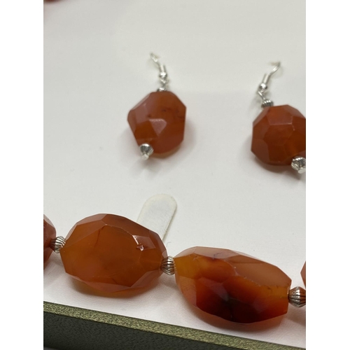 30 - A large beaded carnelian necklace and matching earrings (beads up to 36mm) Total weight 152g. In a p... 