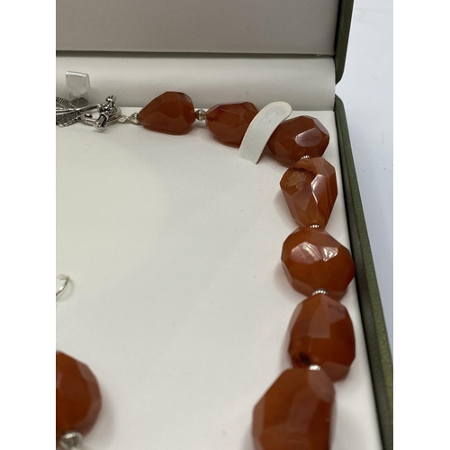 30 - A large beaded carnelian necklace and matching earrings (beads up to 36mm) Total weight 152g. In a p... 