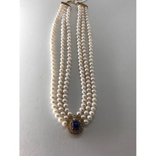 249 - Pearl triple row necklace with Rubies and Sapphires, Thai Cabochon Sapphire 9x11x8mm centre stone ,s... 