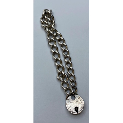 437 - Vintage Silver Bracelet with silver coin padlock, weight 27g and 21cm long approx