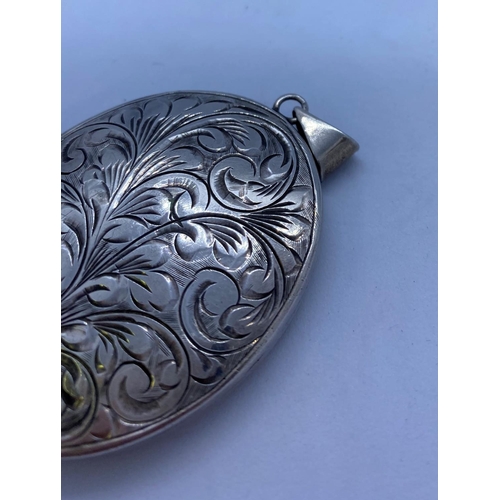 90 - Large Vintage Silver Locket. Oval Shape with Foliage Scrollwork to Cover and Plain Silver Back. 5cm ... 