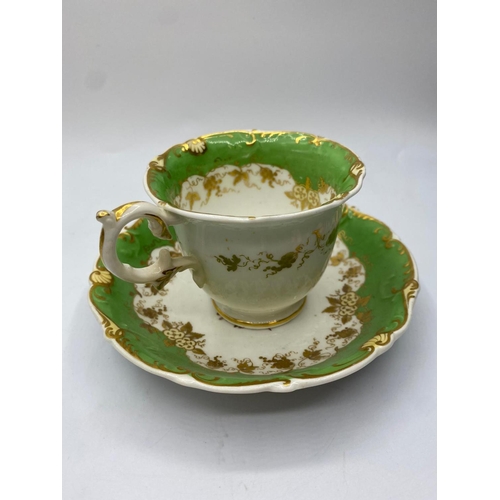 147 - First gadroon shape cup and saucer with small piece missing from handle.