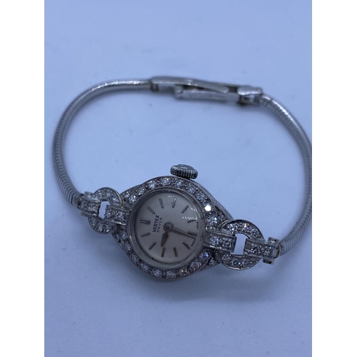 188 - Vintage Vertex Revue Ladies Watch with a Diamond Encrusted Platinum Case and 9ct Gold Strap, 19g.