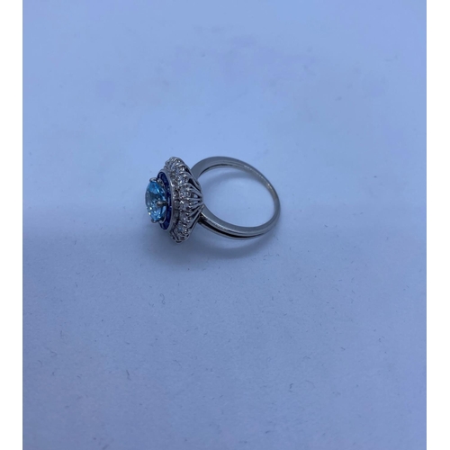 278 - 18ct White Gold Ring with Aqua Marine Centre Stone Surrounded by Sapphires and Diamonds, 6.8g, Size ... 