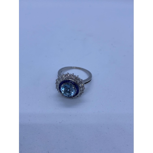 278 - 18ct White Gold Ring with Aqua Marine Centre Stone Surrounded by Sapphires and Diamonds, 6.8g, Size ... 