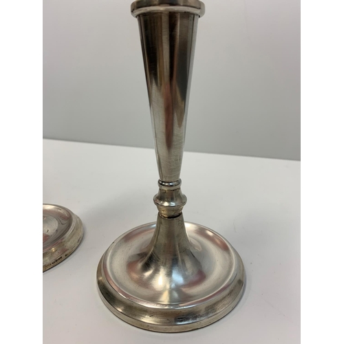 187 - A pair of silver tapered candle sticks, both 25cms tall and 854g.