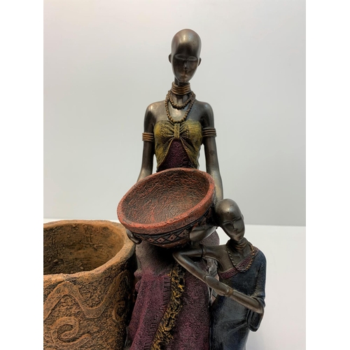 189 - Unusual African sculpture of 2 women and their cooking pots, made from clay with metallic finish. 30... 