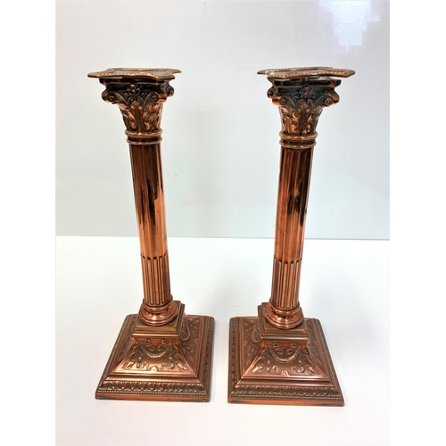 521 - A Pair of Antique Copper Corinthian Column Candlesticks, 32cm tall and 2kg weight (2)