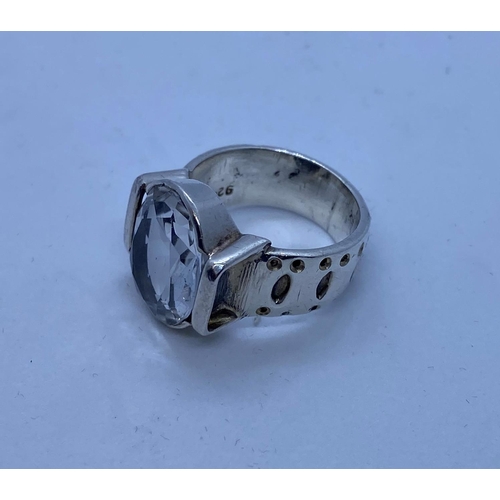 491 - Silver Stone Set Ring Having a Large Clear Aquamarine Stone to Centre. Silver Band has Design Work a... 