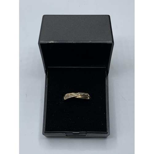 509 - 9ct gold ring with 0.25ct diamonds in crossover design, weight 1.75g and size M/N