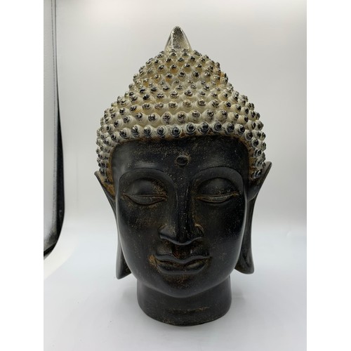 591 - 2x Buddha Heads, one ornate wooden and a heavy ceramic one, 26 &30cm tall (2)