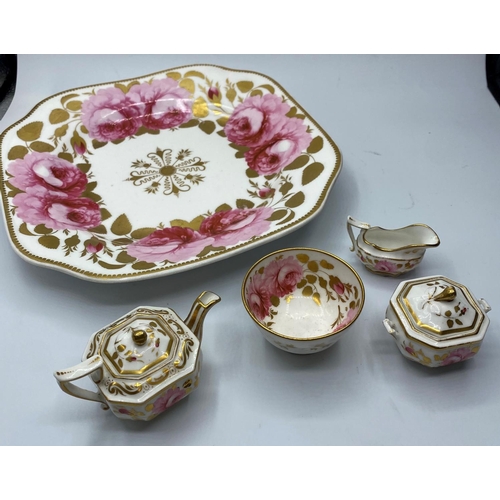 594 - An interesting miniature set of teapot, sugar box, bowl and creamer on a Ribbon & wreath shape plate... 