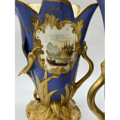 620 - Pair of Daniel blue and gold gilded vases, 17.5cm tall,some mottling to paint finish.A/F.