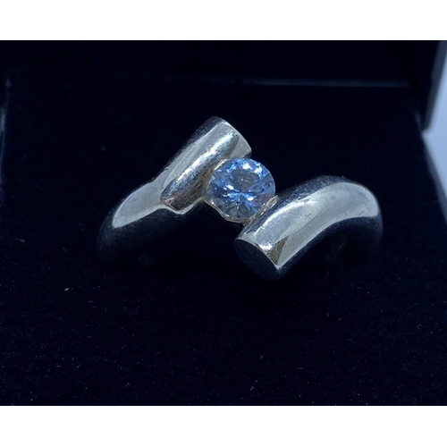 631 - Silver ring in modernist setting with blue topaz stone at centre size M