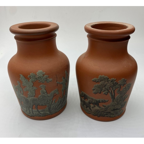 663 - Pair of Terracota pots, 11cm tall with hunting, fishing and shooting decoration (2)