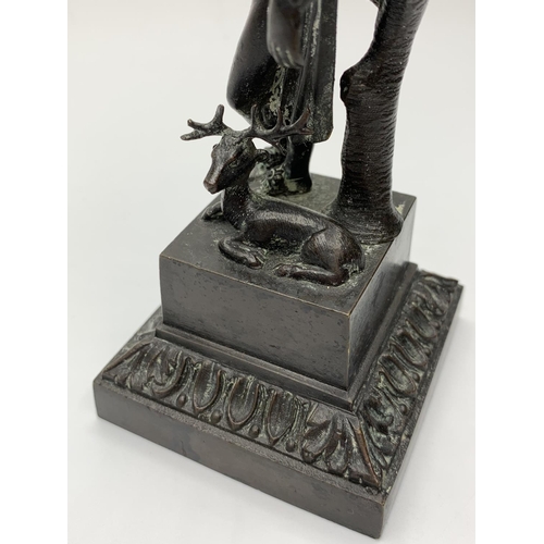 175 - Small bronze statue of a man and deer, 14cms tall and weighs 564g.