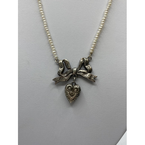 364 - Freshwater Pearl Necklace with Silver Bow and Heart Pendant, 14.2g, 38cms.