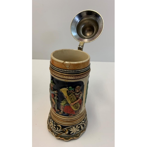 375 - 2 Bavarian style musical tankards with lids. 22x24cms tall.