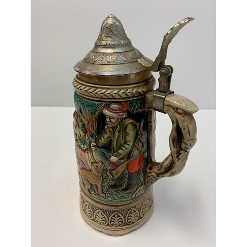 375 - 2 Bavarian style musical tankards with lids. 22x24cms tall.