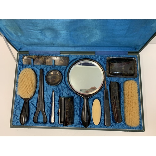 464 - An Antique Ladies Tortoise shell grooming set in a satin lined vanity case.Very good condition.