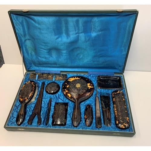 464 - An Antique Ladies Tortoise shell grooming set in a satin lined vanity case.Very good condition.