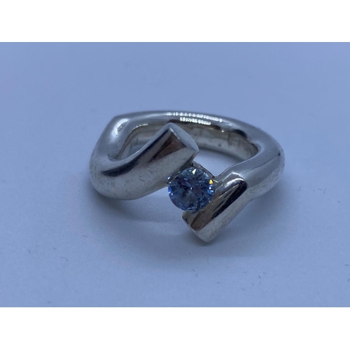 631 - Silver ring in modernist setting with blue topaz stone at centre size M