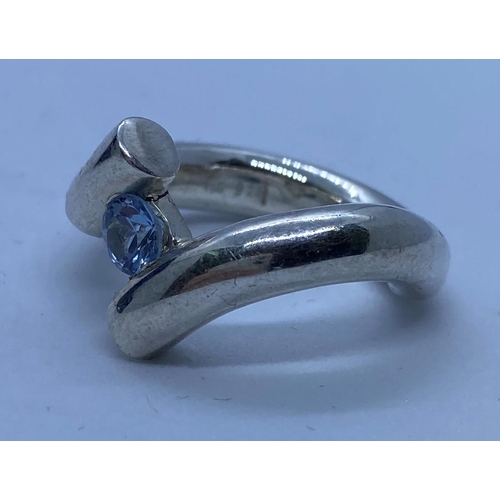 631 - Silver ring in modernist setting with blue topaz stone at centre size M