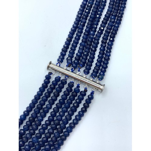 103 - A seven row of faceted. 3-4mm dark blue sapphire beads necklace. Length 44-59cm. Weight 92g