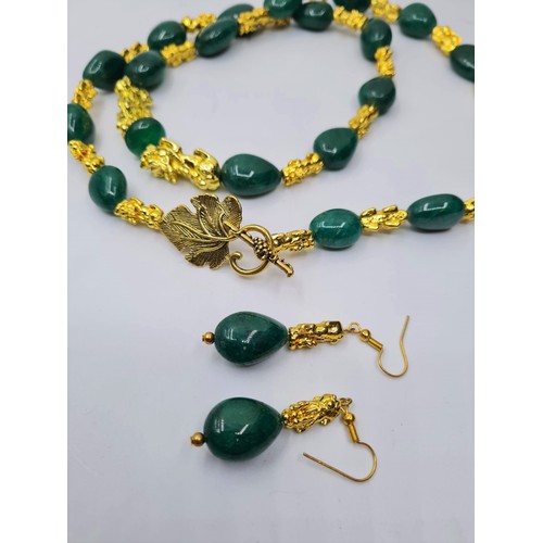 101 - An emerald and 18k gold filled foo dogs necklace and matching earrings set. Necklace length 77cm. To... 