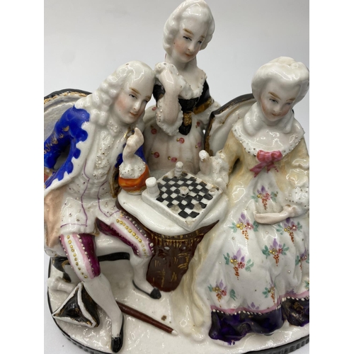 665 - Ceramic statue of a Dandy Playing chess with his lady admirers, 10x14cm