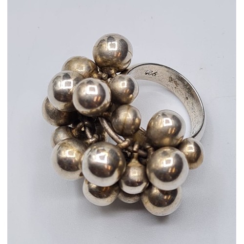 275 - Silver cluster ring having approx 22 Silver balls in cluster formation. Stamped 925. Size O.