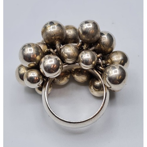 275 - Silver cluster ring having approx 22 Silver balls in cluster formation. Stamped 925. Size O.