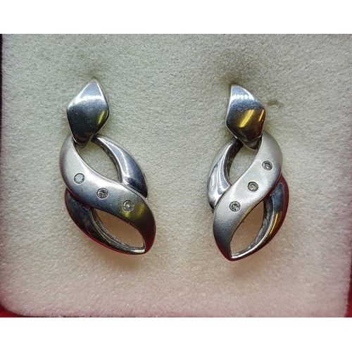 277 - Pair of Diamond Set Silver Earrings. Having three diamonds to each earring. Marked 925 Silver.