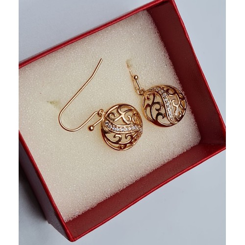 287 - Pair of gold on silver filigree earrings. Circular form with centre clear stone strip. Marked 925 si... 