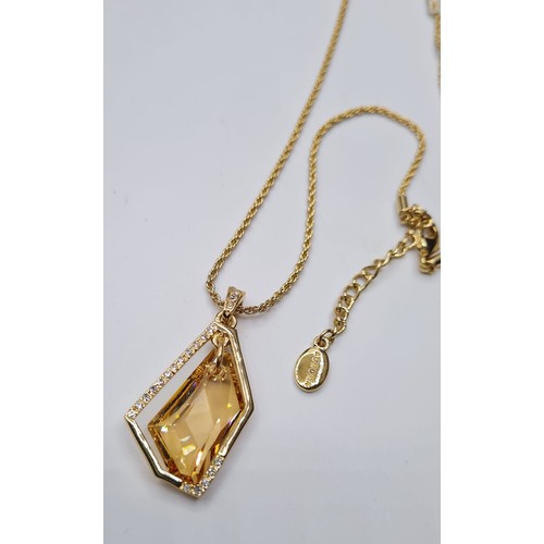 291 - A Swarovski Crystal Pendant in a modern stone set mount by Aurora. Complete with gilded chain of 43c... 