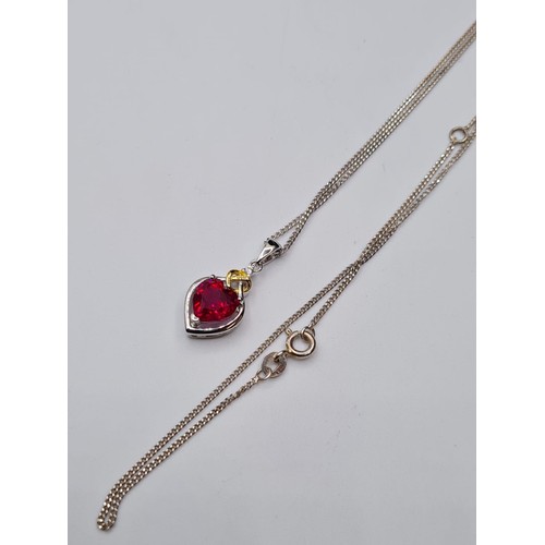 308 - Stone Set silver Pendant and Chain. Having a Heart Shaped Ruby Coloured Stone with Silver Heart Surr... 