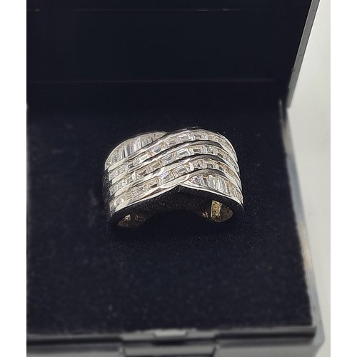 343 - Silver ring with wide band at the top having five rows of clear stones. Size L/M