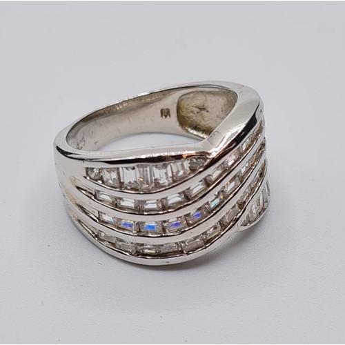 343 - Silver ring with wide band at the top having five rows of clear stones. Size L/M