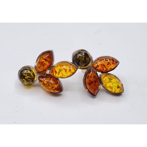 349 - Pair of stone set silver and amber earrings.
Each earring having three different shades of Amber and... 