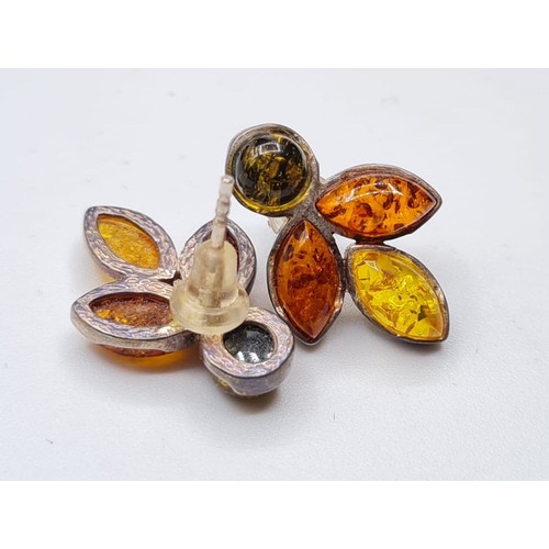 349 - Pair of stone set silver and amber earrings.
Each earring having three different shades of Amber and... 