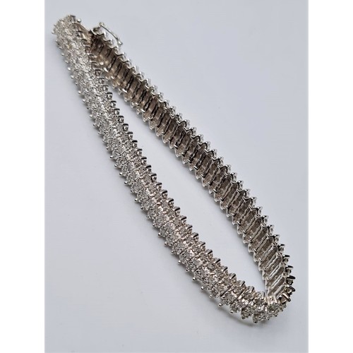 320 - 9ct white gold diamond set 3 row bracelet, weight 19g approx 1.25ct. Size 18cms