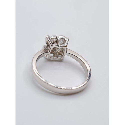 385 - 18CT WHITE GOLD DIAMOND SET FLOWER HEAD RING, WEIGHT 4.3G AND 0.40CT APPROX. SIZE O