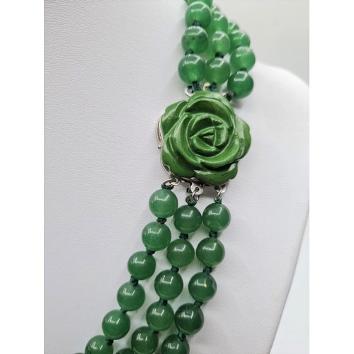 88 - A three row green jade necklace with green jade clasp. Length 48-54cm. Total weight: 124g