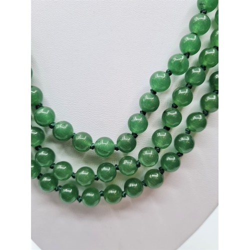 88 - A three row green jade necklace with green jade clasp. Length 48-54cm. Total weight: 124g