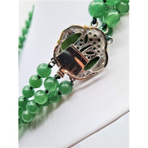 88 - A three row green jade necklace with green jade clasp. Length 48-54cm. Total weight: 124g